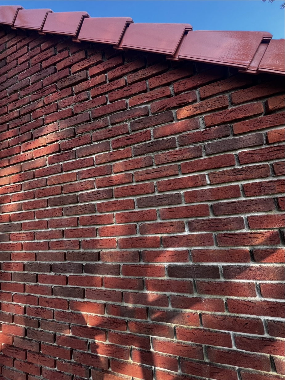 Close-up van metselwerk aan een gevel met dakpannen